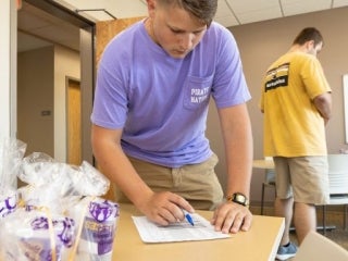Student signing in at a table